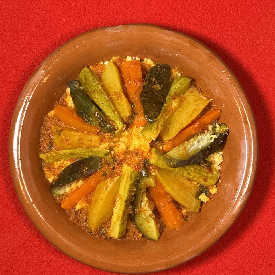 Close-up of steamed vegetables over hand-rolled semolina