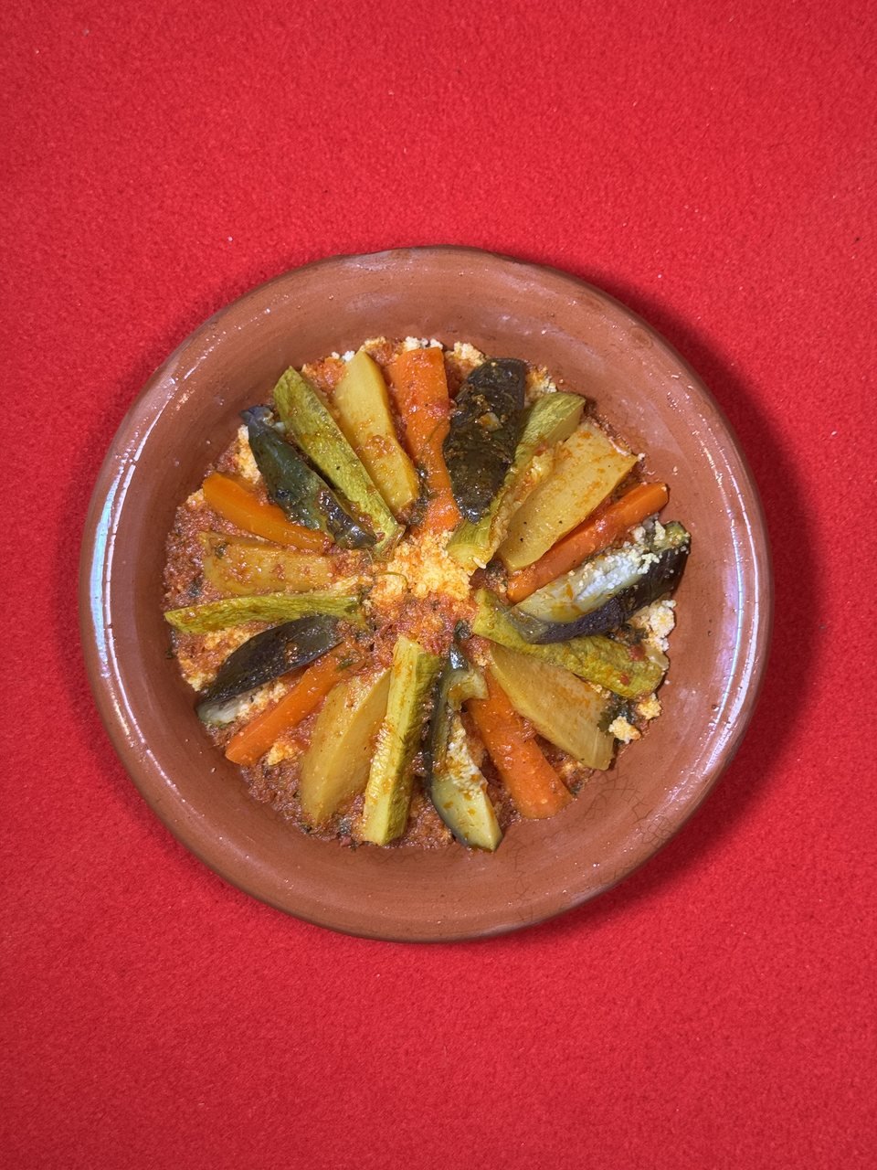 Moroccan couscous on the red felt table of Bigua Café