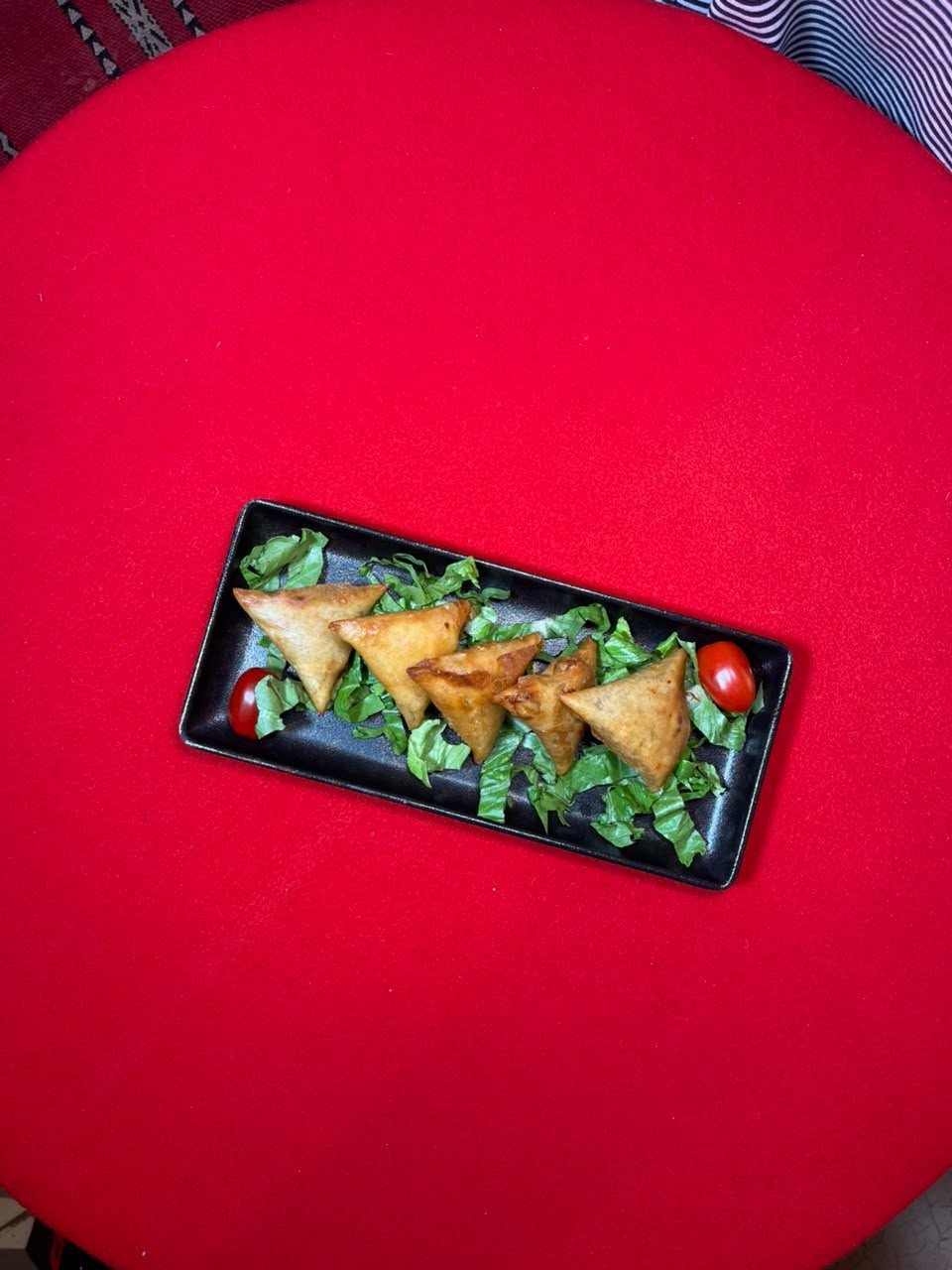 Golden briouates arranged on a slate plate