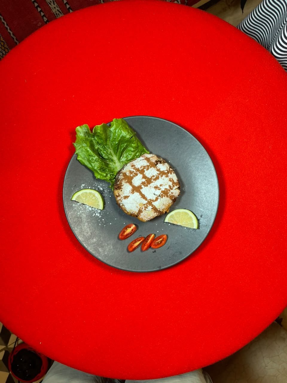 A grilled plate served with fresh lettuce and lime