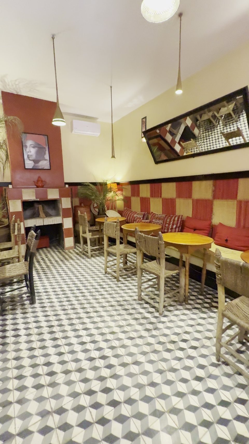 The main salon with its fireplace, portrait and red-and-white checkered dado