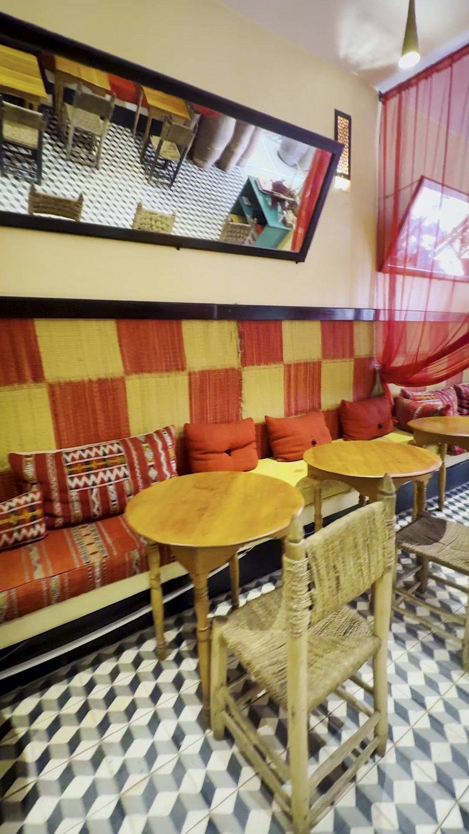 Banquette seating against the red-and-cream checkered wall