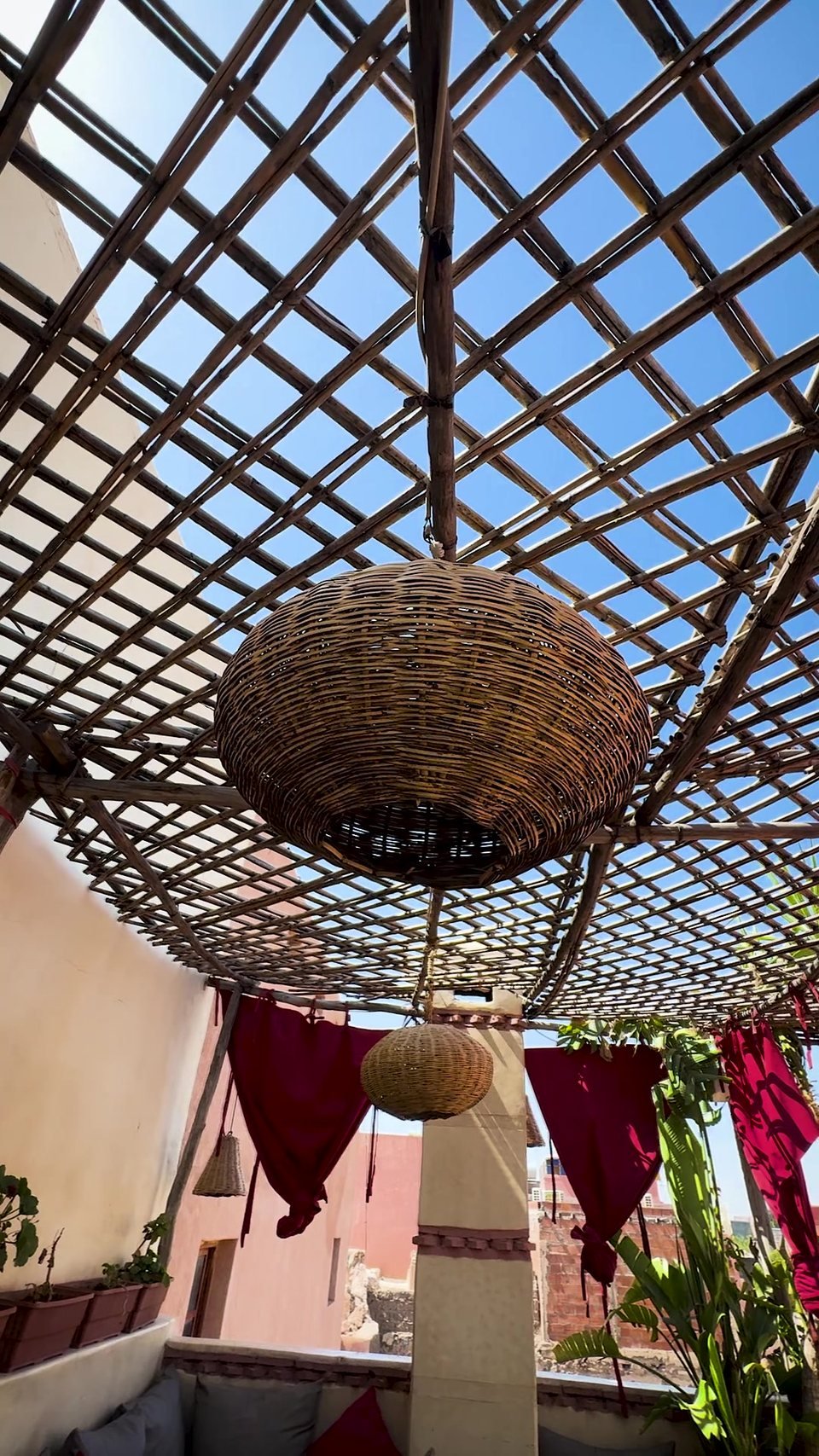 Tables set for dinner under the rooftop pergola